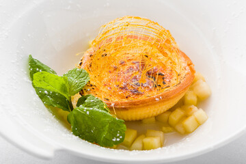 Crème brûlée tart with spun sugar and mint
