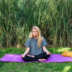 Relaxed female athlete performing a morning mindfulness routine on a mat