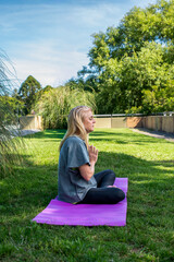 Healthy lifestyle concept with a woman meditating in a lotus position