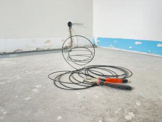 Pliers and Electrical Cable on Floor During Home Renovation