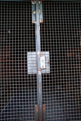 Rusty Metal Grid Gate With Lock and Industrial Texture