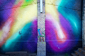 Fototapeta premium Colourful Rainbow Graffiti Mural on Brick Wall Background