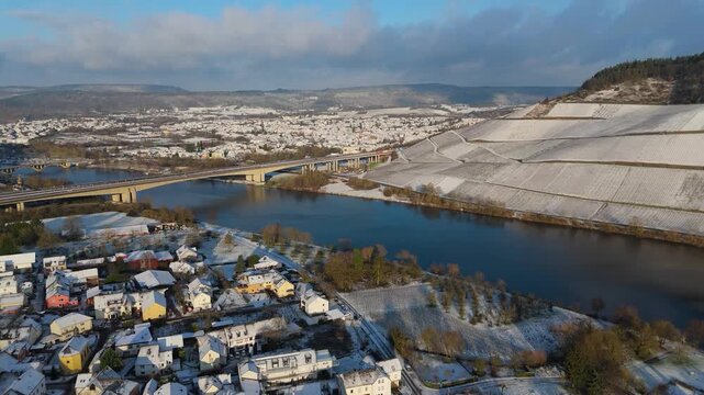 Snow covered Moselle valley, vineyard and Mosel river, Viaduct Longuich bridge of highway crossing near Trier, aerial view, winter season with frost in Germany