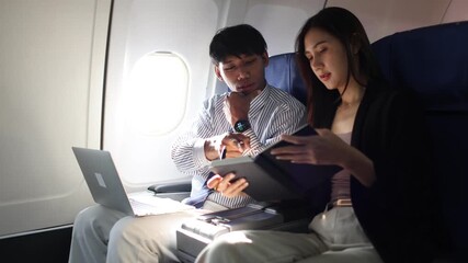 Successful business partners manage a private jet meeting, utilizing high-end technology and teamwork to discuss strategy and luxury travel connections. - Powered by Adobe