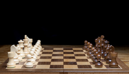 chess pieces on a chessboard, game set and ready to play