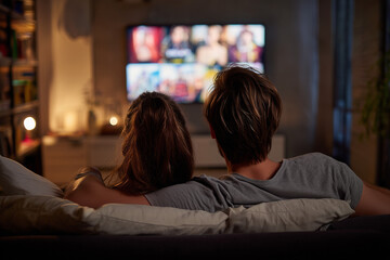 Couple watching a streaming movie on a couch at home, streaming provider, streaming services 