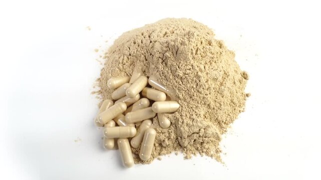 Ashwagandha powder and pills as supplement isolated on white background