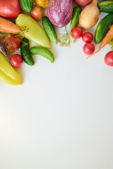 Ripe organic raw vegetables laid out on a white background. Top view.
