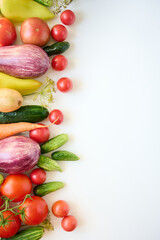 Ripe organic raw vegetables laid out on a white background. Top view.