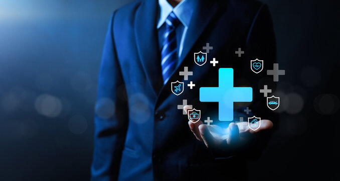 Insurance and healthcare protection concept with businessman holding digital medical cross and shield icons. Health coverage, risk management, financial security, medical service, safety. - Powered by Adobe
