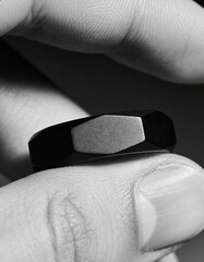 Macro Shot of Hand Wearing Matte Black Ring on Dark Minimal Background, Modern Masculine Jewelry Style for Luxury Branding, Fashion Editorials, Contemporary Design, and Premium Visual Concepts