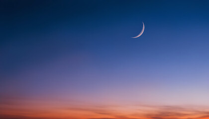 Captivating crescent moon gently shining in a beautiful gradient twilight sky