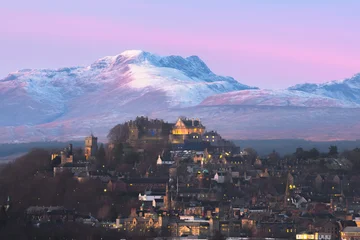 Epic winter landscape and cityscape view of Stirling Castle at twilight with mountain backdrop and peaks of Stuc a'Chroin and Ben Vorlich in the Scottish Highlands of Scotland, UK. © Stephen