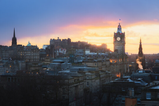 Classic cityscape view of Edinburgh old town skyline, Balmoral Clock Tower and Edinburgh Castle from Calton Hill with a dramatic sunset in the capital city of Scotland.