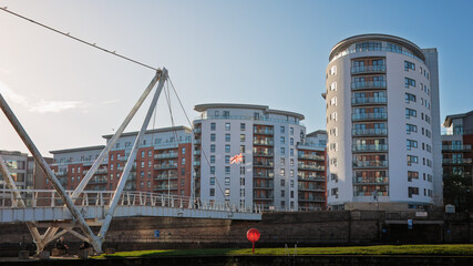 Obraz premium Winter sun on Leeds Skyline from Leeds Dock on the River Aire, Leeds, West Yorkshire, England November 2025.