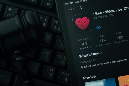 Dhaka, Bangladesh- 28 Oct 2025: An iPad displaying the Likee app against a judge's gavel and dark keyboard background.