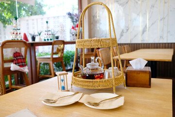 A tea set with desserts and a teapot.