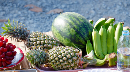 Arranging fruits as offerings to sacred beings.