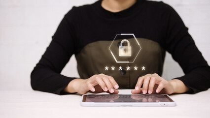 Person Typing Password on Tablet with Virtual Padlock Icon for Cybersecurity and Data Protection