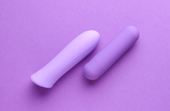 Sex toys. Set of clitoral vibrators on purple background