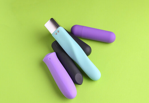 Sex toys. Set of clitoral vibrators on green background