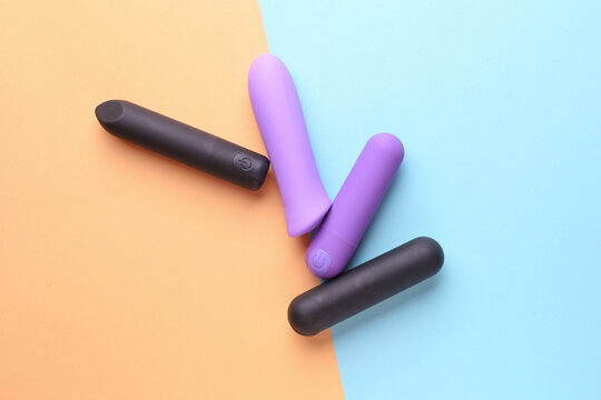 Sex toys. Set of clitoral vibrators on pink blue background. Top view