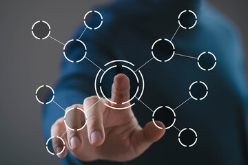 Hand touching central node of connected digital network interface. Concept of system integration,...