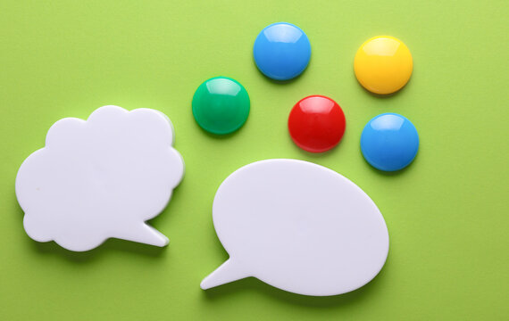 Different fridge magnets on a green background