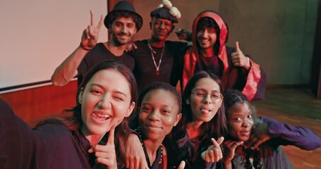 Indian young adult gen z male man female look camera take selfie photos have fun joy hall stage place. Happy teen girl boy group team staring cam do funny pose record video spend day enjoy break time