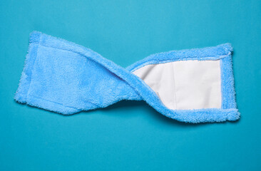 Shaggy mop rag on blue background