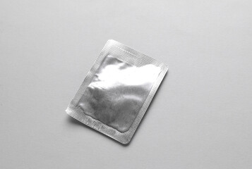 Blank aluminum texture sachet packet mockup on gray background. Empty disposable shampoo or conditioner pack mock up for your design