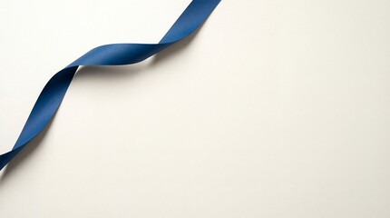 Elegant deep blue satin ribbon gracefully curving across a clean light beige background with soft shadows and gentle light creating a minimalist and sophisticated