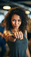 Energetic Fitness Motivation: Young Woman Punching Forward in Gym