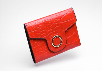 Red crocodile leather wallet floating on white background