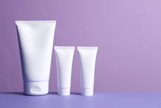 Cream tubes on a purple background