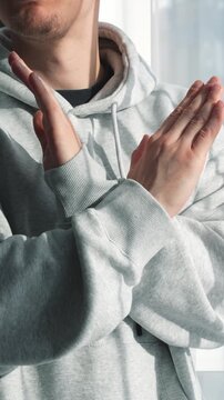 A NO gesture with the hands.
A person makes a gesture of refusal and categoricalness with their hands.
Protest and rejection.
A dissatisfied man refuses an offer.