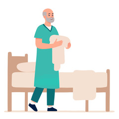 Elderly man dressed in scrubs carrying bed linens in a hospital room . Elderly set