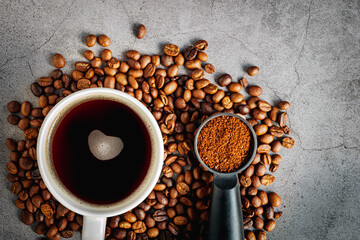 Coffee cup with coffee beans and ground coffee on gray background, Americano cup aromatic top view