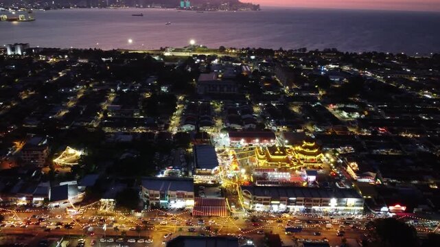 Raja Uda town at night. There are many lights on the buildings and streetlights