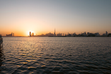 Naklejka premium panorama view of Dubai Downtown skyline with creek harbor view at sunset, 4k background wallpaper