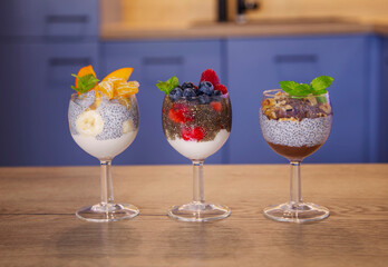 chia pudding with berries and yogurt on a blue kitchen