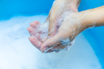Fototapeta premium Hands Washing with Soap and Foam in Clean Water, Close-up, Wash hands hygiene, sanitation, disease prevention, and sustainable water use for health