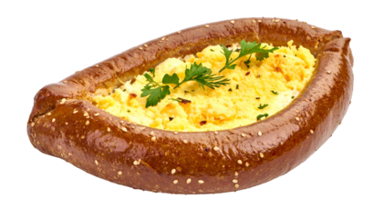 Oval baked bread with scrambled eggs filling, garnished with parsley, on black