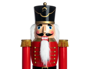 Wooden soldier in red coat with black hat and white beard, standing against black background