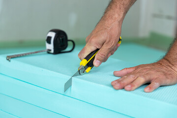 Construction Worker Cutting Insulation Boards
