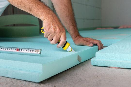 Worker Cutting Out Insulation Board