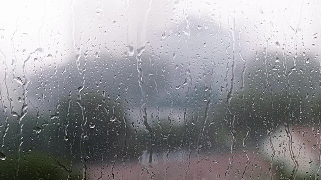 Raindrops on window pane during a heavy storm - 4K Cinematic