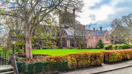 A view along the city walls across a green park towards the cathedral in the city of Chester, Cheshire, UK