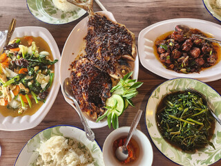 Barbecue fish and vegetables dishes, lunch meal in Rantepao, Tana Toraja, Sulawesi, Indonesia