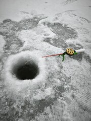 Winter Ice Fishing: Frozen Lake Hole and Fishing Rod